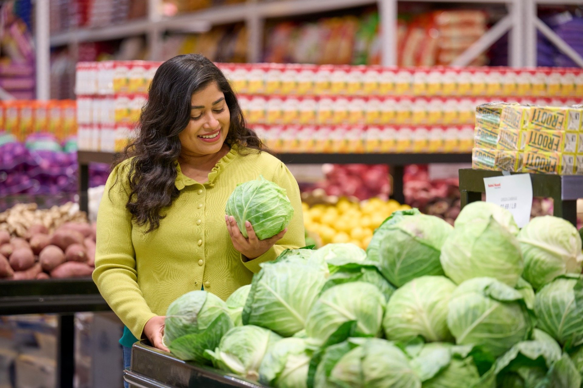 Customer choosing fresh cabbage at Subzi Mandi
